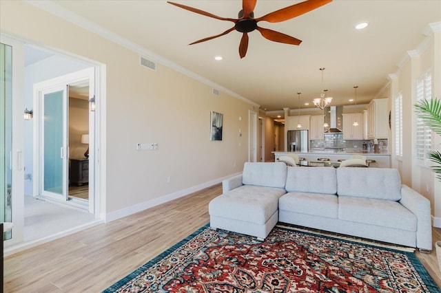 501 Tamiami Trl N Unit 201, Venice, FL 34285 - living area with crown molding, ceiling fan, light wood finished floors, recessed lighting, and a chandelier