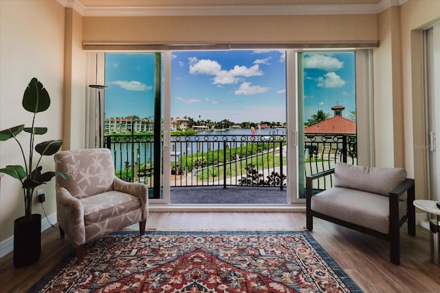 501 Tamiami Trl N Unit 201, Venice, FL 34285 - living area with a water view, wood finished floors, ornamental molding, and healthy amount of natural light