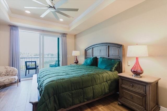501 Tamiami Trl N Unit 201, Venice, FL 34285 - bedroom featuring a tray ceiling, access to outside, crown molding, light wood-style floors, and recessed lighting