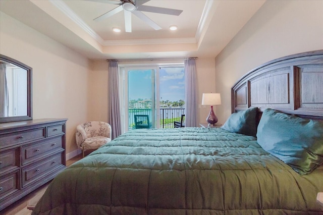 501 Tamiami Trl N Unit 201, Venice, FL 34285 - bedroom with access to exterior, a raised ceiling, crown molding, wood finished floors, and ceiling fan