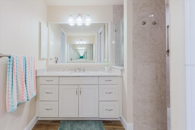 501 Tamiami Trl N Unit 201, Venice, FL 34285 - full bathroom with tiled shower, vanity, and wood finished floors