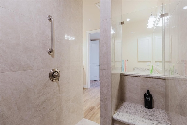 501 Tamiami Trl N Unit 201, Venice, FL 34285 - bathroom featuring walk in shower and wood finished floors