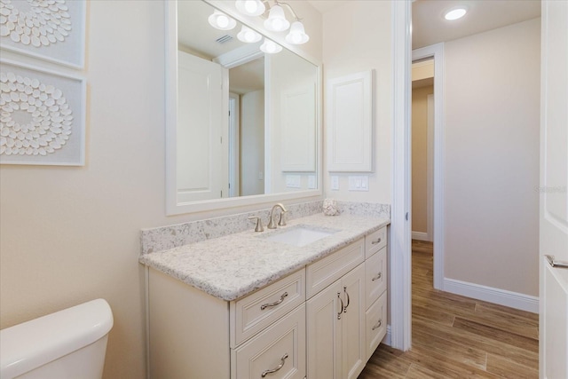 501 Tamiami Trl N Unit 201, Venice, FL 34285 - half bathroom with vanity, wood finished floors, and recessed lighting