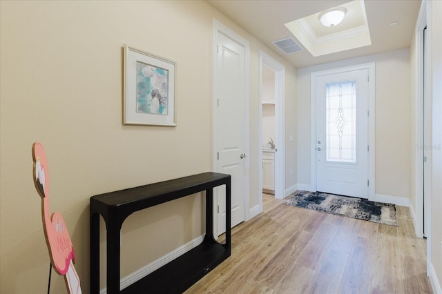 501 Tamiami Trl N Unit 201, Venice, FL 34285 - entryway featuring light wood-type flooring, a raised ceiling, and crown molding