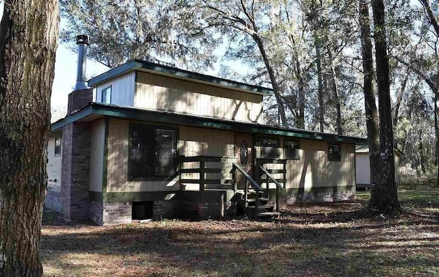 1123 NW 192nd Ave, Gainesville, FL 32609 - view of home's exterior featuring a chimney and crawl space