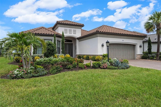 3968 Santa Caterina Blvd, Bradenton, FL 34211 - mediterranean / spanish house with a garage, a front lawn, a tiled roof, stucco siding, and stone siding