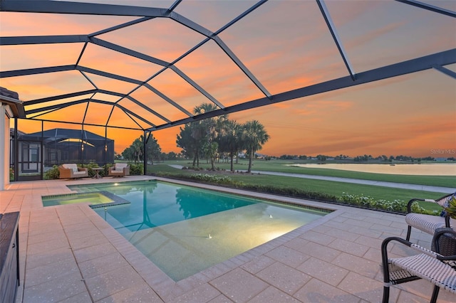 3968 Santa Caterina Blvd, Bradenton, FL 34211 - pool at dusk featuring a patio area, a pool with connected hot tub, and a lanai