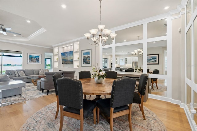 3968 Santa Caterina Blvd, Bradenton, FL 34211 - dining space with a chandelier, ornamental molding, light wood-type flooring, recessed lighting, and a raised ceiling