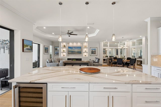 3968 Santa Caterina Blvd, Bradenton, FL 34211 - kitchen with beverage cooler, open floor plan, ornamental molding, a raised ceiling, and a ceiling fan
