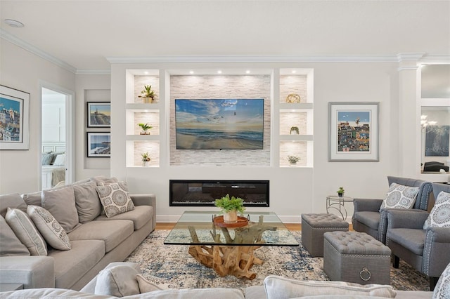 3968 Santa Caterina Blvd, Bradenton, FL 34211 - living area featuring ornamental molding, wood finished floors, built in shelves, and a glass covered fireplace
