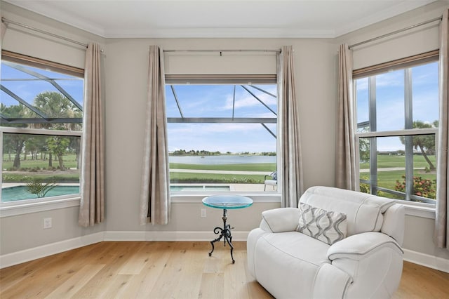 3968 Santa Caterina Blvd, Bradenton, FL 34211 - sitting room with ornamental molding, light wood-style floors, and a water view