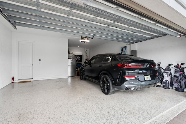 3968 Santa Caterina Blvd, Bradenton, FL 34211 - garage featuring a garage door opener and water heater