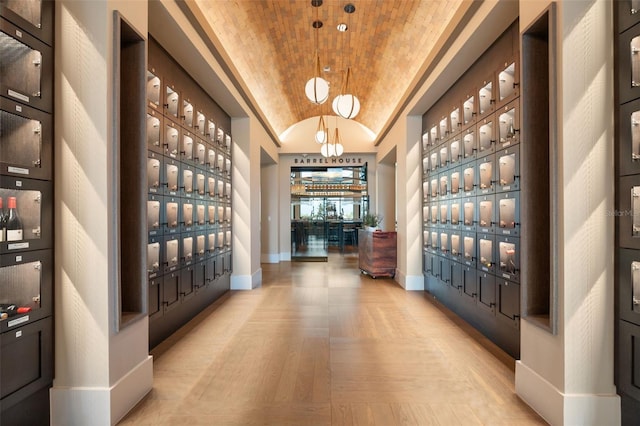 3968 Santa Caterina Blvd, Bradenton, FL 34211 - wine room with lofted ceiling, wood finished floors, and a chandelier