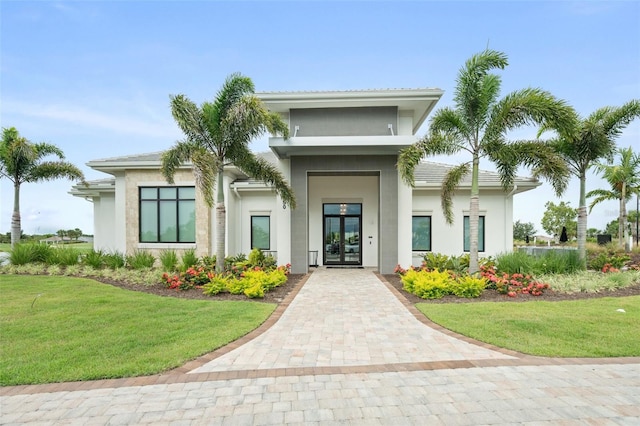 3968 Santa Caterina Blvd, Bradenton, FL 34211 - doorway to property with french doors, stucco siding, and a yard