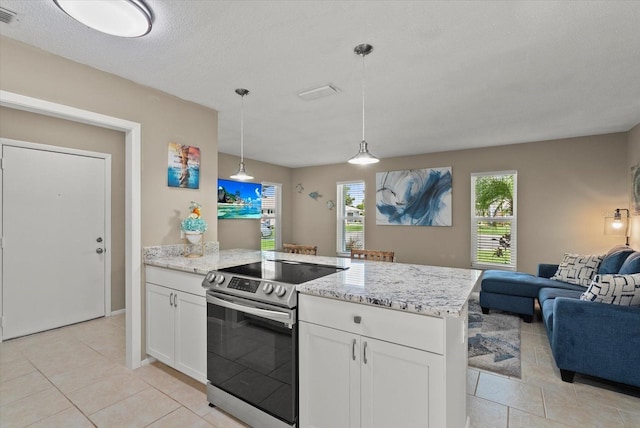 4309 Chinaberry Cir, Bradenton, FL 34208 - kitchen featuring stainless steel electric range, open floor plan, a peninsula, white cabinets, and a textured ceiling