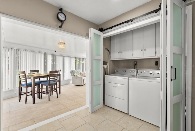 4309 Chinaberry Cir, Bradenton, FL 34208 - washroom with cabinet space, washer and clothes dryer, and light tile patterned floors