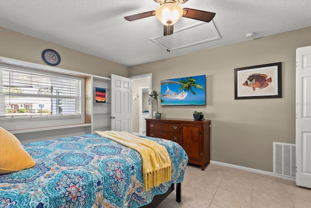 4309 Chinaberry Cir, Bradenton, FL 34208 - bedroom with light tile patterned floors, a textured ceiling, a ceiling fan, and attic access