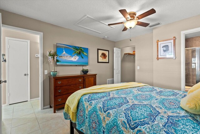 4309 Chinaberry Cir, Bradenton, FL 34208 - bedroom with attic access, light tile patterned flooring, a ceiling fan, a textured ceiling, and ensuite bathroom