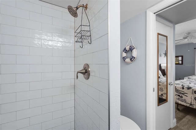 6310 Midnight Pass Rd Unit 405N, Sarasota, FL 34242 - ensuite bathroom with tiled shower, ceiling fan, and wood finished floors