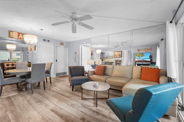 6310 Midnight Pass Rd Unit 405N, Sarasota, FL 34242 - living area featuring ceiling fan, a chandelier, light wood-type flooring, and a textured ceiling
