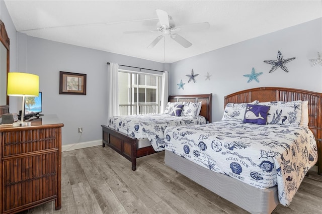 6310 Midnight Pass Rd Unit 405N, Sarasota, FL 34242 - bedroom featuring wood finished floors and a ceiling fan
