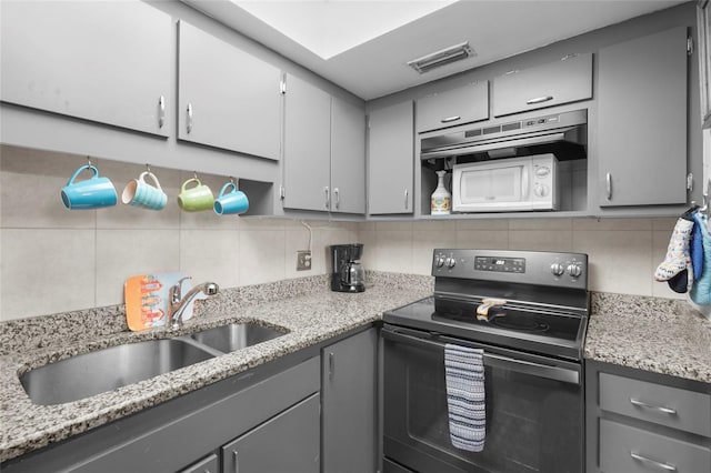 6310 Midnight Pass Rd Unit 405N, Sarasota, FL 34242 - kitchen featuring range with electric stovetop, gray cabinets, decorative backsplash, and light stone counters
