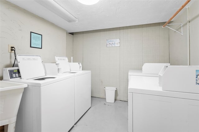 6310 Midnight Pass Rd Unit 405N, Sarasota, FL 34242 - shared laundry featuring independent washer and dryer and a textured ceiling