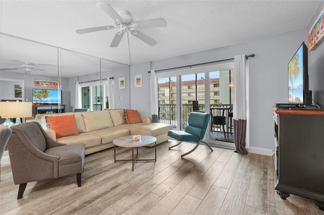 6310 Midnight Pass Rd Unit 405N, Sarasota, FL 34242 - living room with ceiling fan, light wood-type flooring, and a textured ceiling