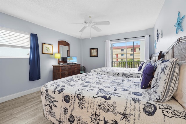 6310 Midnight Pass Rd Unit 405N, Sarasota, FL 34242 - bedroom with wood finished floors, multiple windows, and a ceiling fan