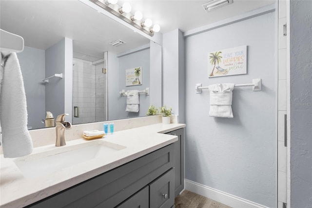 6310 Midnight Pass Rd Unit 405N, Sarasota, FL 34242 - bathroom featuring vanity, wood finished floors, and a tile shower