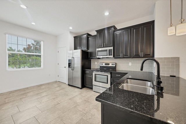 6454 Baytown Dr, Sarasota, FL 34240 - kitchen featuring stainless steel appliances, backsplash, dark stone countertops, dark cabinets, and recessed lighting