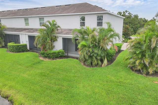 6454 Baytown Dr, Sarasota, FL 34240 - rear view of house with a yard, a shingled roof, and stucco siding