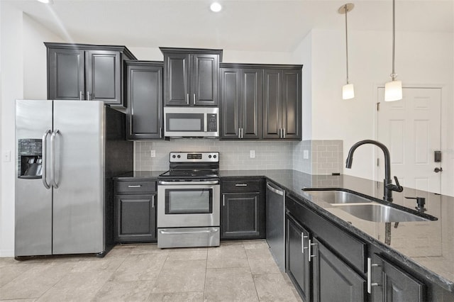 6454 Baytown Dr, Sarasota, FL 34240 - kitchen featuring stainless steel appliances, dark stone countertops, backsplash, pendant lighting, and dark cabinets