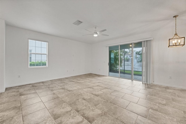 6454 Baytown Dr, Sarasota, FL 34240 - empty room with healthy amount of natural light, a chandelier, and a ceiling fan