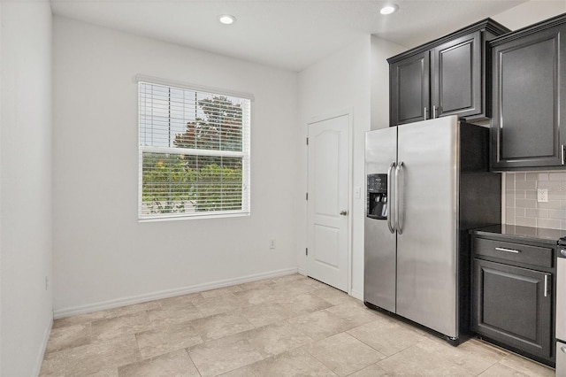 6454 Baytown Dr, Sarasota, FL 34240 - kitchen featuring stainless steel refrigerator with ice dispenser, decorative backsplash, dark countertops, and recessed lighting