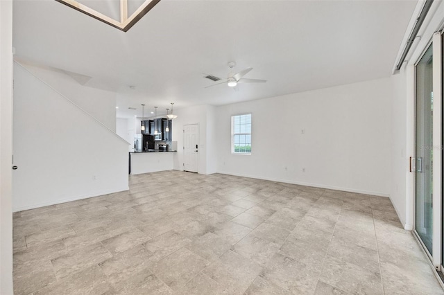 6454 Baytown Dr, Sarasota, FL 34240 - unfurnished living room featuring ceiling fan and baseboards