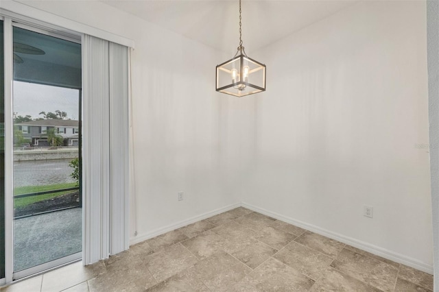 6454 Baytown Dr, Sarasota, FL 34240 - unfurnished dining area with a chandelier and baseboards