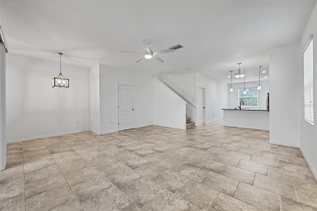 6454 Baytown Dr, Sarasota, FL 34240 - unfurnished living room with stairway and a ceiling fan