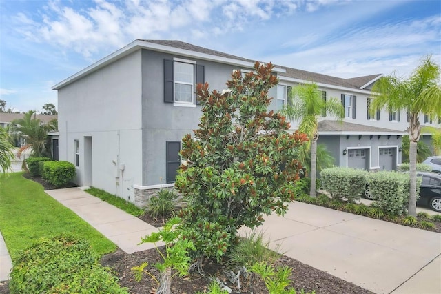 6454 Baytown Dr, Sarasota, FL 34240 - view of front facade with stucco siding, a garage, and driveway