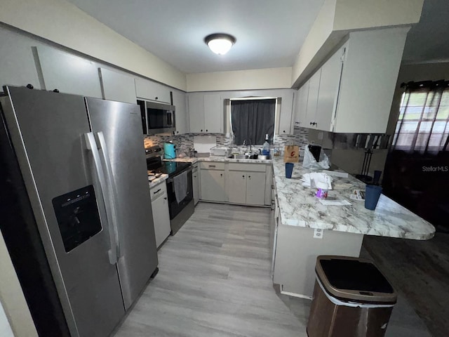 629 Spring Oaks Blvd, Altamonte Springs, FL 32714 - kitchen featuring appliances with stainless steel finishes, backsplash, light countertops, and light wood-type flooring