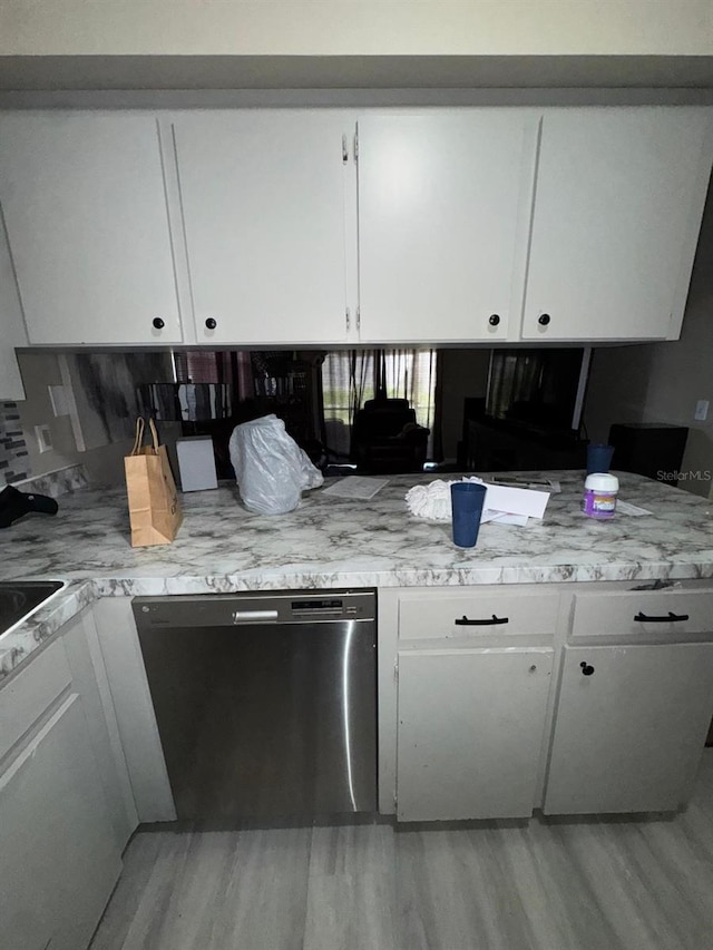 629 Spring Oaks Blvd, Altamonte Springs, FL 32714 - kitchen featuring stainless steel dishwasher, white cabinetry, and light countertops