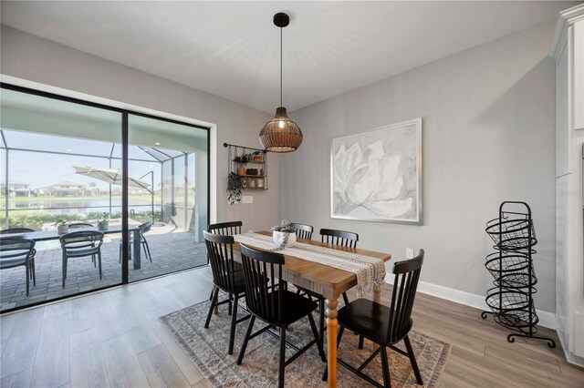16418 Slate Pl, Lakewood Ranch, FL 34211 - dining space with a sunroom and wood finished floors