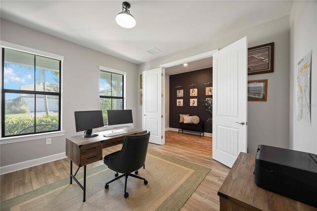16418 Slate Pl, Lakewood Ranch, FL 34211 - home office with baseboards and light wood-style floors