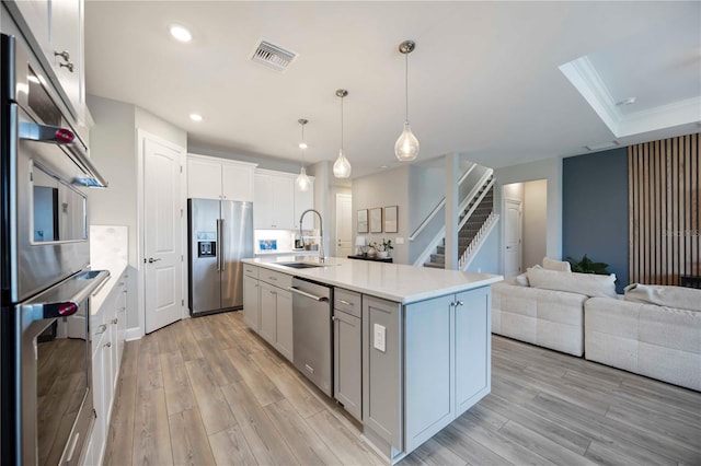 16418 Slate Pl, Lakewood Ranch, FL 34211 - kitchen with appliances with stainless steel finishes, light wood-style floors, light countertops, recessed lighting, and open floor plan