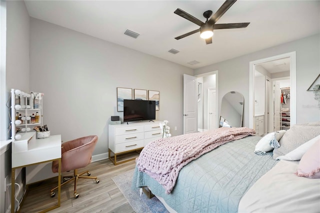 16418 Slate Pl, Lakewood Ranch, FL 34211 - bedroom with light wood-style flooring, ceiling fan, and ensuite bath