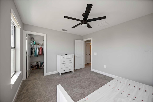 16418 Slate Pl, Lakewood Ranch, FL 34211 - unfurnished bedroom with a walk in closet, carpet floors, a closet, and a ceiling fan