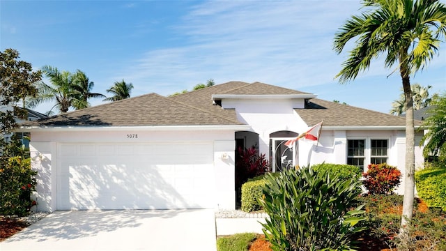 5078 47th St W, Bradenton, FL 34210 - single story home featuring a garage, roof with shingles, concrete driveway, and stucco siding