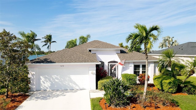 5078 47th St W, Bradenton, FL 34210 - ranch-style house with a garage, concrete driveway, stucco siding, and roof with shingles