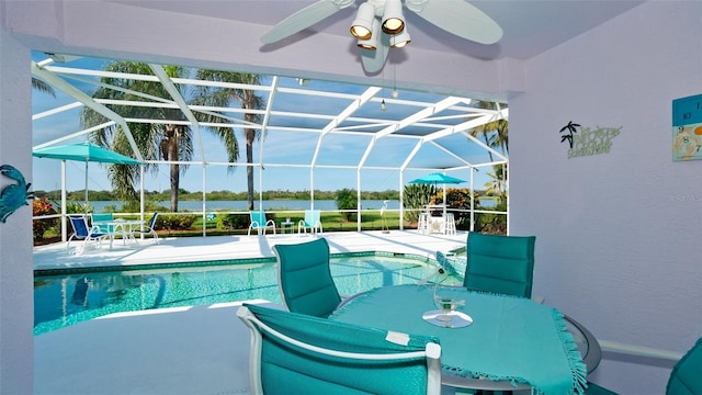 5078 47th St W, Bradenton, FL 34210 - swimming pool featuring a ceiling fan, a patio area, glass enclosure, and outdoor dining space