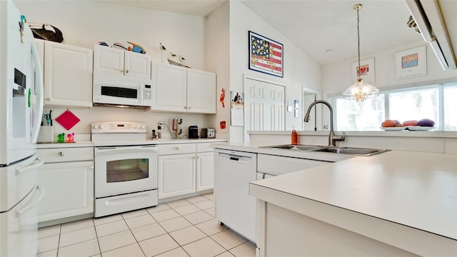 5078 47th St W, Bradenton, FL 34210 - kitchen featuring white appliances, light tile patterned floors, pendant lighting, white cabinets, and light countertops